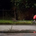 A boy rides his bike through still water after a thunderstorm in the Lakewood area of East Houston, which flooded during Hurricane Harvey.