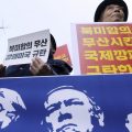 Protesters hold a banner showing images, of President Trump, Secretary of State Mike Pompeo, and National Security Adviser John Bolton during a rally against U.S. sanctions on North Korea, near the U.S. Embassy in Seoul, South Korea.