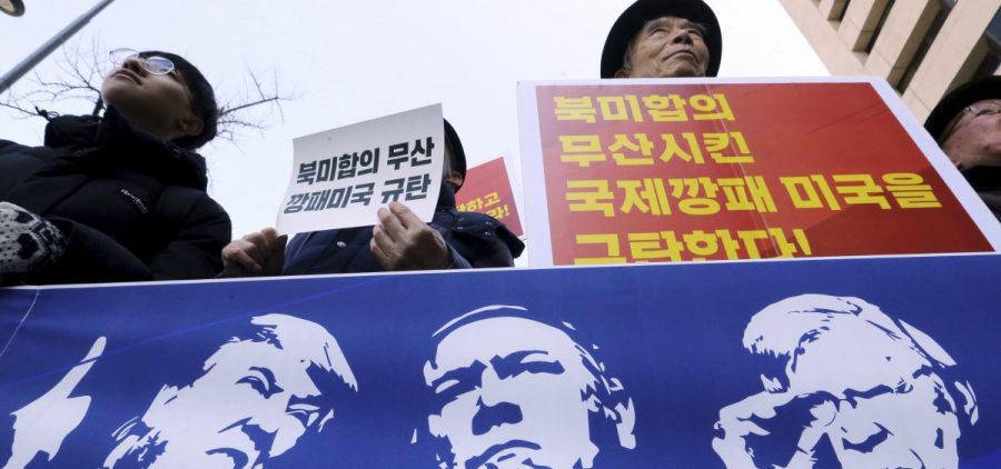 Protesters hold a banner showing images, of President Trump, Secretary of State Mike Pompeo, and National Security Adviser John Bolton during a rally against U.S. sanctions on North Korea, near the U.S. Embassy in Seoul, South Korea.