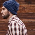 This is the unedited version of a contested photo from an MIT Technology Review article on hipsters. Original caption: "Shot of a handsome young man in trendy winter attire against a wooden background."