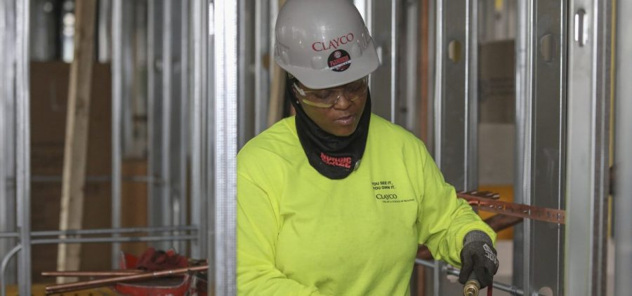 Plumber Zakiyyah Askia welds pipes at a high-rise residence under construction in Chicago on Jan. 24. U.S. employers added 196,000 jobs in March, a rebound from February's weak growth, the Labor Department said Friday.