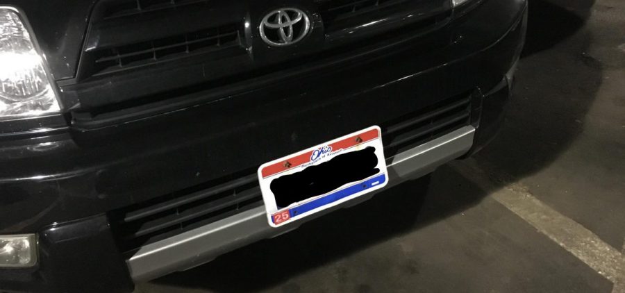 A front license plate with blurred out numbers