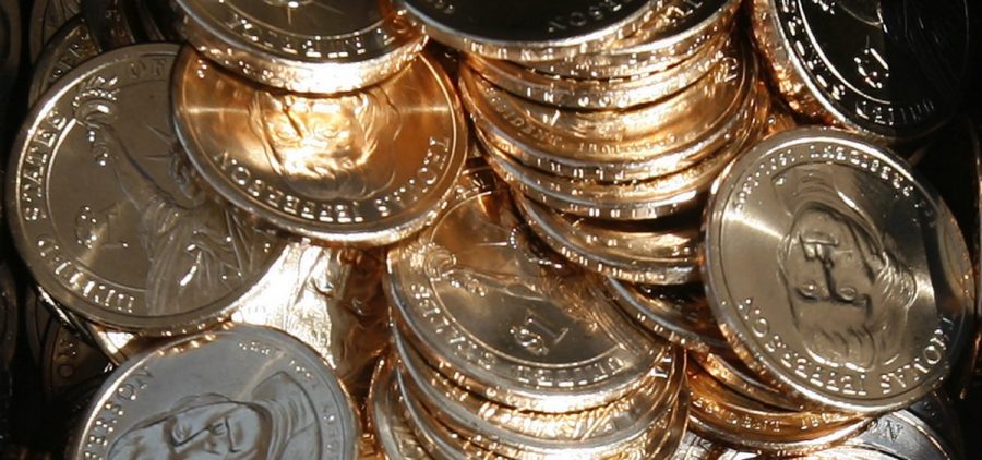 A pile of newly minted one-dollar coins honoring former Thomas Jefferson are seen at the unveiling by the U.S. Mint in Washington, D.C., in 2007. In a turnaround, congressional analysts are no longer recommending a phaseout of paper dollars in favor a dollar coin.