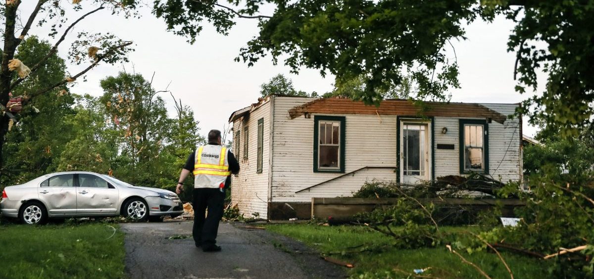 Storm damage litters a residential neighborhood, in Dayton, Ohio, Tuesday, after a rapid-fire line of apparent tornadoes tore across Indiana and Ohio overnight. The storms were packed so closely together that one crossed the path carved by another.