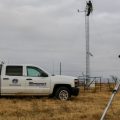 Meteorological Electronics Technicians Christopher Bieschke and Kirk Wilson replace a wind sensor atop a 30-foot tower at an Oklahoma Mesonet station near Shawnee, Okla.