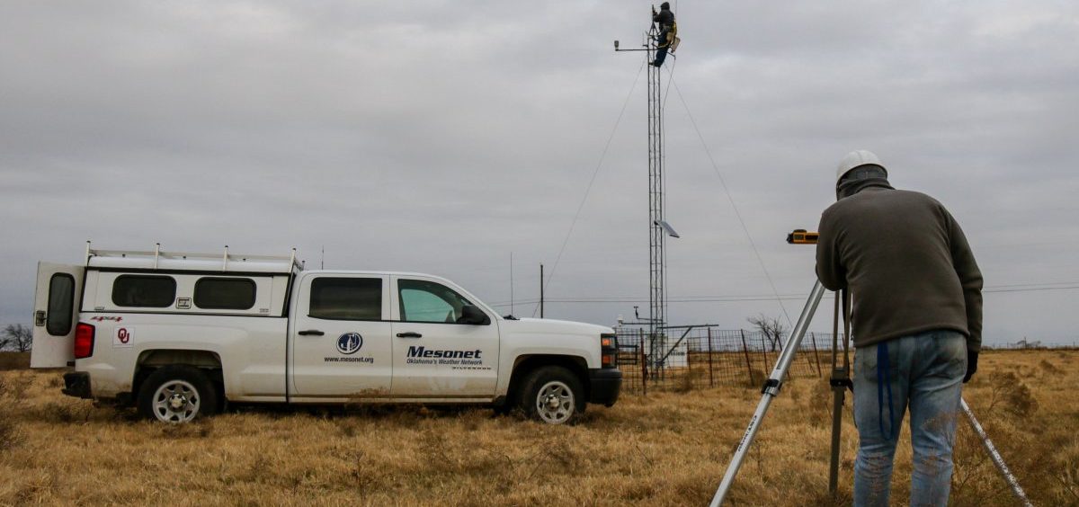 Meteorological Electronics Technicians Christopher Bieschke and Kirk Wilson replace a wind sensor atop a 30-foot tower at an Oklahoma Mesonet station near Shawnee, Okla.