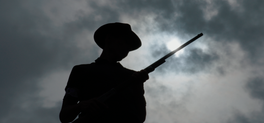 silhouette of man with rifle