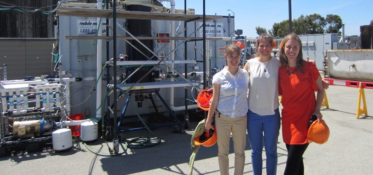 Anne Schauer-Gimenez (from left) Allison Pieja and Molly Morse of Mango Materials stand next to the biopolymer fermenter at a sewage treatment plant next to San Francisco Bay. The fermenter feeds bacteria the methane they need to produce a biological form of plastic.