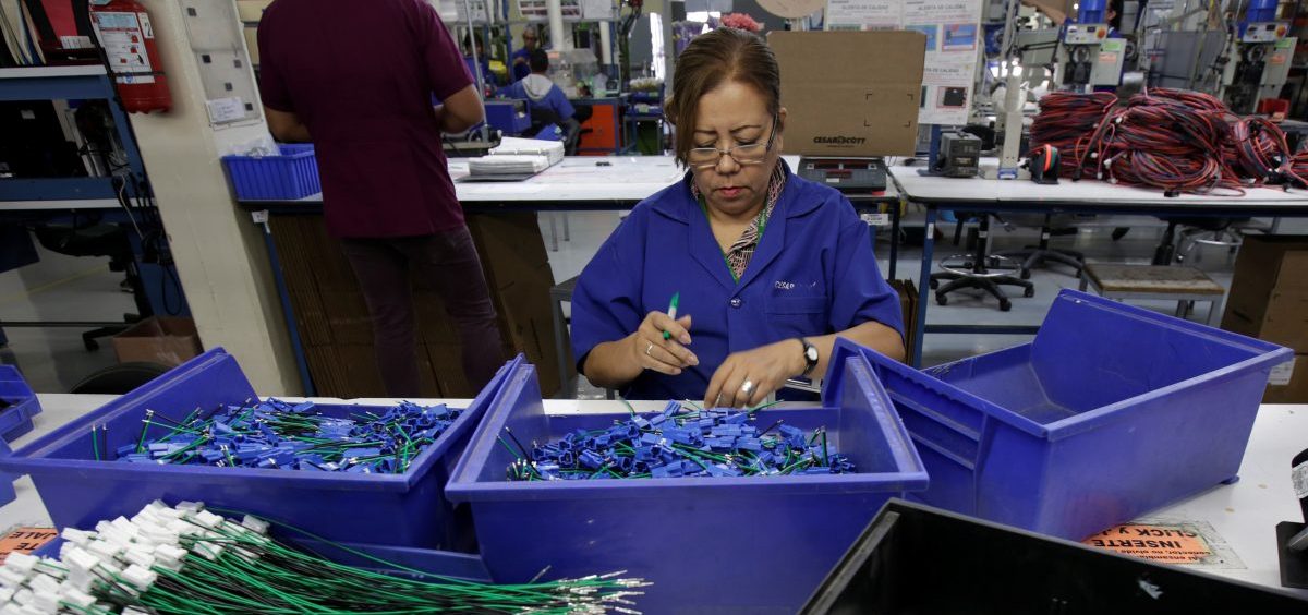 An employee works at a wiring harness and cable assembly manufacturing company in Ciudad Juárez, Mexico, that exports to the U.S. in 2017. The auto industry says threatened tariffs would play havoc with supply chains.
