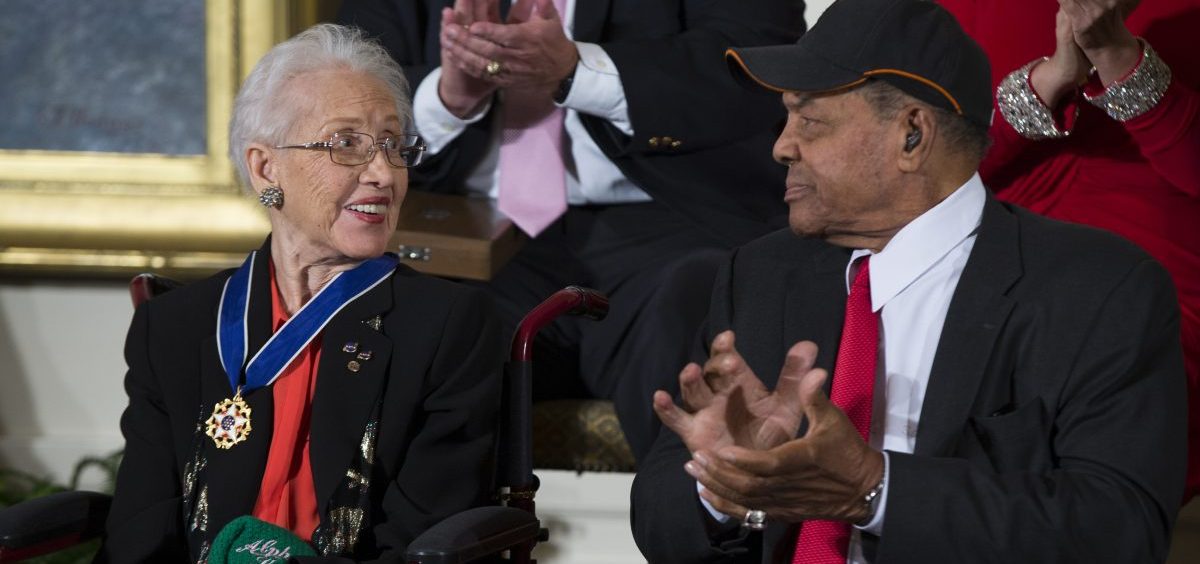 FILE - In a Nov. 24, 2015 file photo, Willie Mays, right, applauds NASA mathematician Katherine Johnson, after she received the Presidential Medal of Freedom from President Barack Obama during a ceremony in the East Room of the White House.
