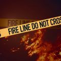 Fire line tape with flames in the background
