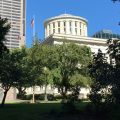 The Ohio Statehouse behind trees
