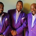 The band The O'Jays in matching purple jackets