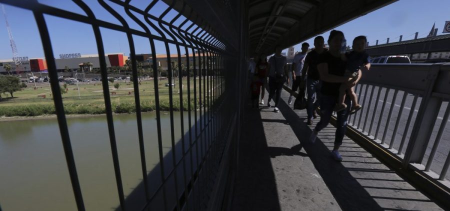 People walk across International Bridge 1 Las Americas, a legal port of entry that connects Laredo, Texas, in the U.S. with Nuevo Laredo, Mexico.