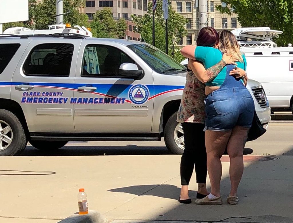 Residents comfort each other as they await word on whether they know any of the victims of a mass shooting on Sunday, Aug. 4, 2019, in Dayton, Ohio. (AP Photo | Julie Carr Smyth)