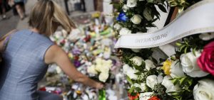 Mourners bring flowers to a makeshift memorial Tuesday, Aug. 6, 2019, for the slain and injured in the Oregon District after a mass shooting that occurred early Sunday morning, in Dayton.