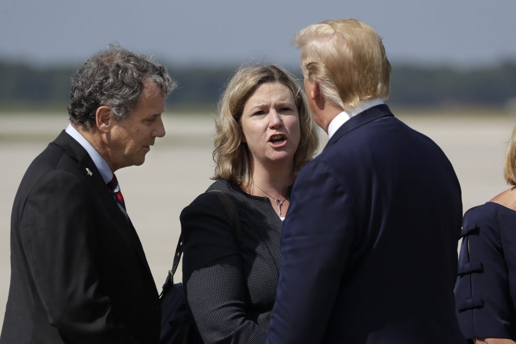President Donald Trump is greeted by Dayton Mayor Nan Whaley and Sen. Sherrod Brown, D-Ohio, after arriving at Wright-Patterson Air Force Base to meet with people affected by the mass shooting in Dayton, Wednesday, Aug. 7, 2019, in Wright-Patterson Air Force Base, Ohio. (AP Photo | Evan Vucci)