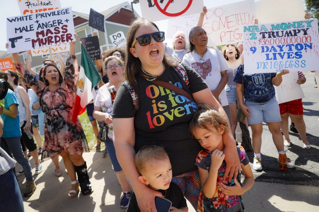 Demonstrators chant as they protest the arrival of President Donald Trump outside Miami Valley Hospital after a mass shooting that occurred in the Oregon District early Sunday morning, Wednesday, Aug. 7, 2019, in Dayton. (AP Photo | John Minchillo)