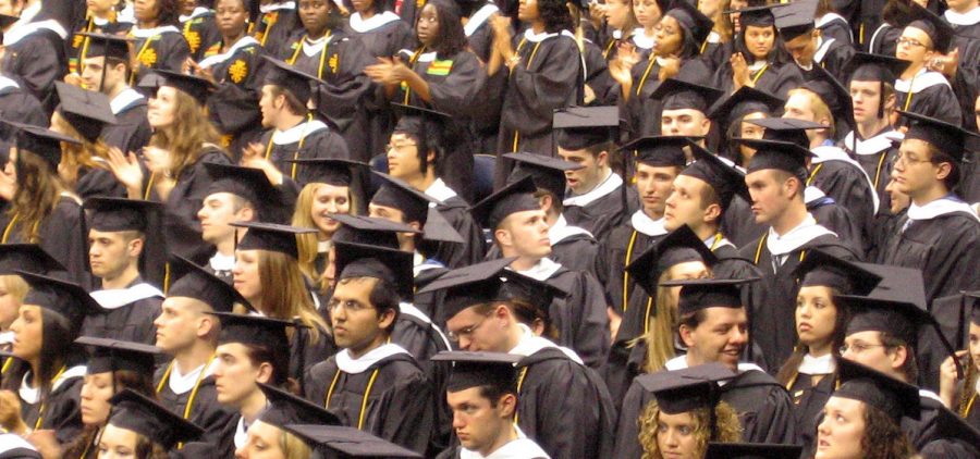 group of students in cap & gown at graduation ceremony