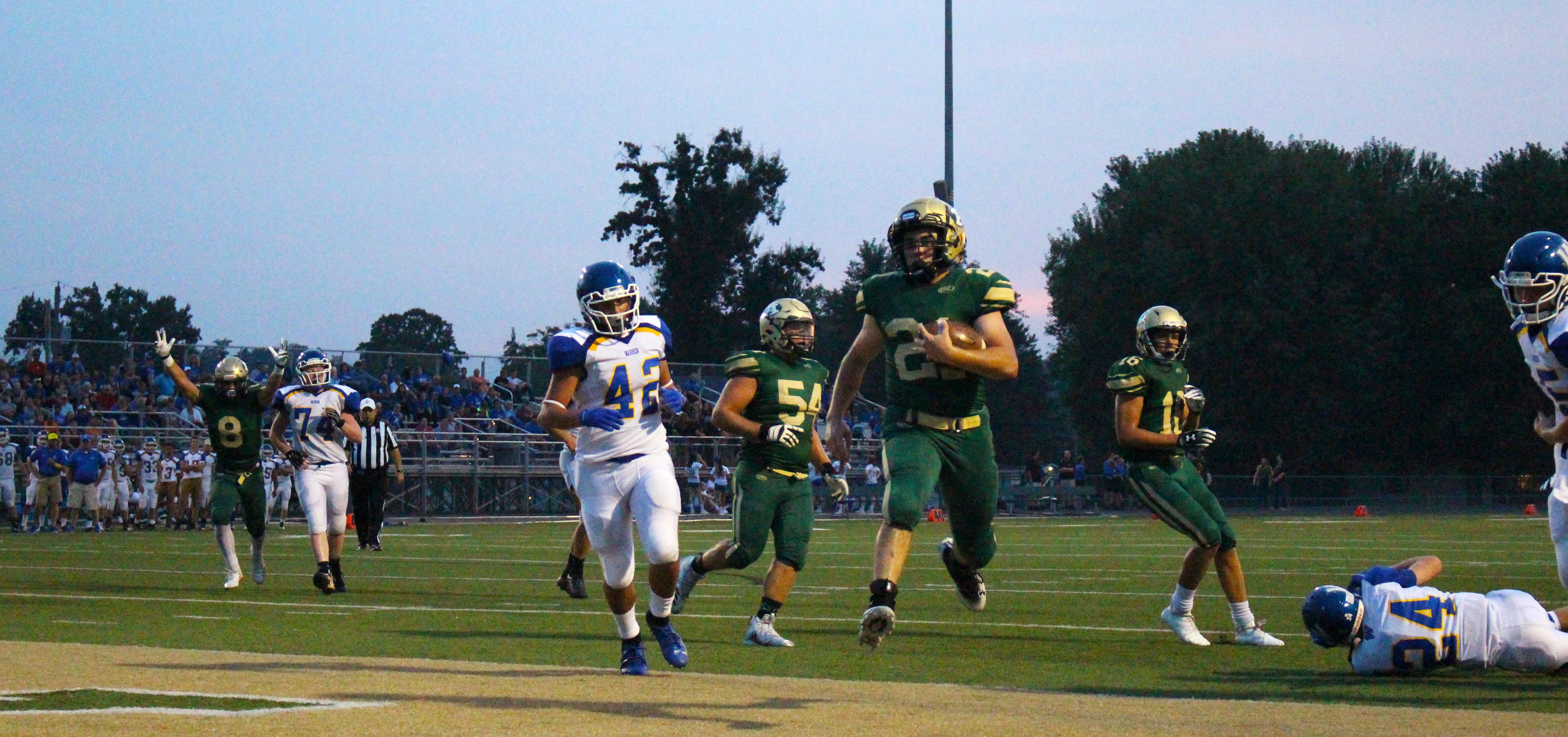 Athens player runs with football.