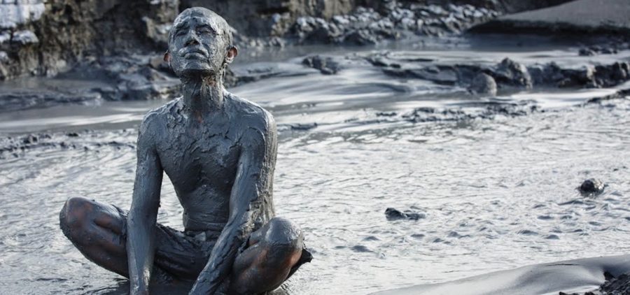 PBS Show POV Grit Documentary - man sitting in Mud