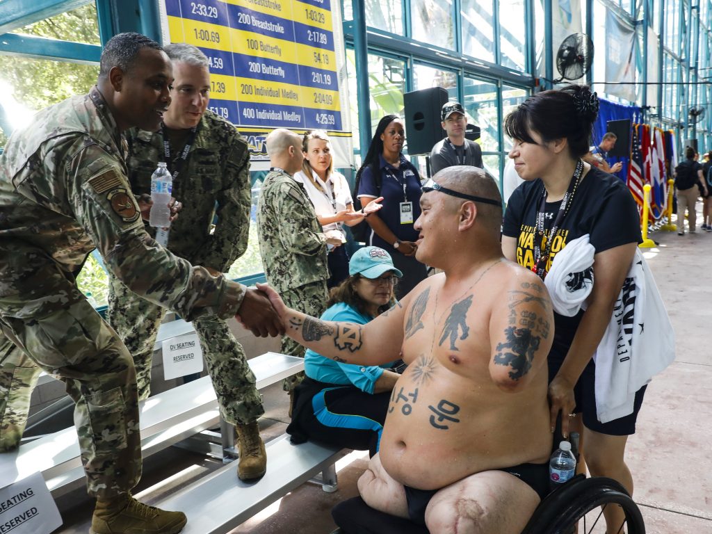 Matt shakes hands with members of the Warrior Games community after his race. "I got a letter saying that I was out of the [caregivers] program because the veteran hasn't shown any progress since 2011," Alicia said. "I asked them, 'What do you mean by progress?' "