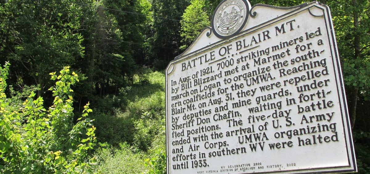 In this June 6, 2011 photo, this historical marker along W.Va. Route 17 in Blair, W.Va., is the only visible sign of the 1921 battle here between thousands of armed, unionizing coal miners and the thousands of law enforcement officers and security guards hired to defeat them. At least 16 men died on the mountain