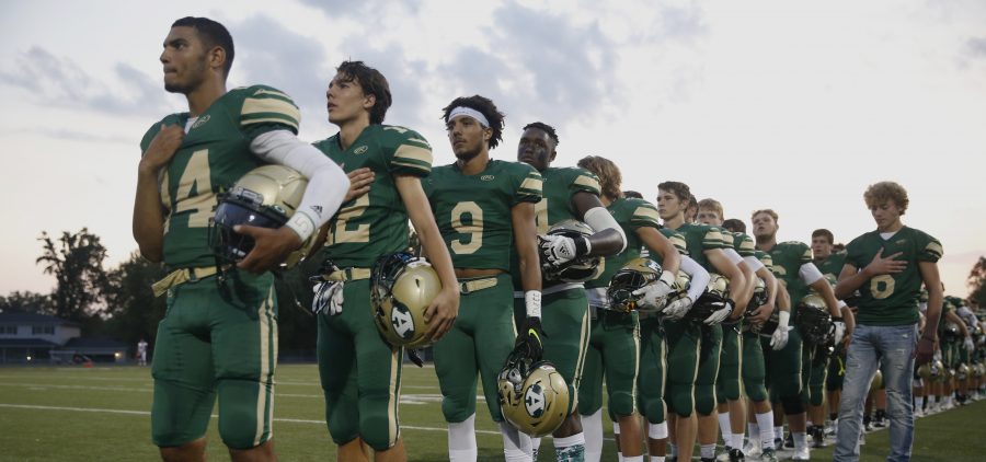 Players of Athens Bulldogs lines up for the national anthem before the game against Alexander Spartans at Athens High School on Sep 20, 2019.