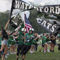 The Waterford Wildcats break through the banner
