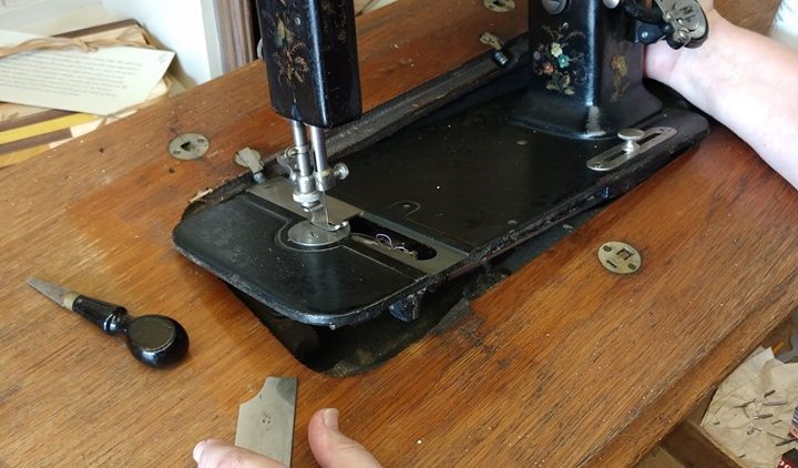 Someone using a vintage sewing machine
