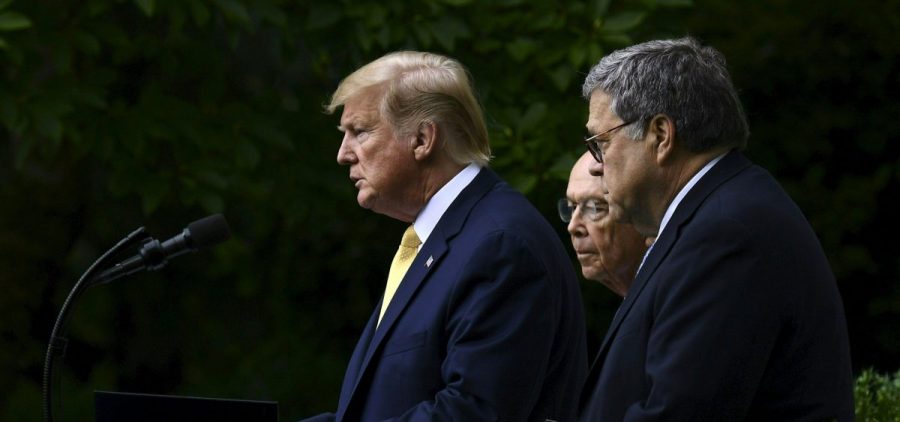 President Trump, flanked by Commerce Secretary Wilbur Ross (back) and U.S. Attorney General William Barr, delivers remarks on citizenship data in the Rose Garden at the White House in Washington, D.C., in July.
