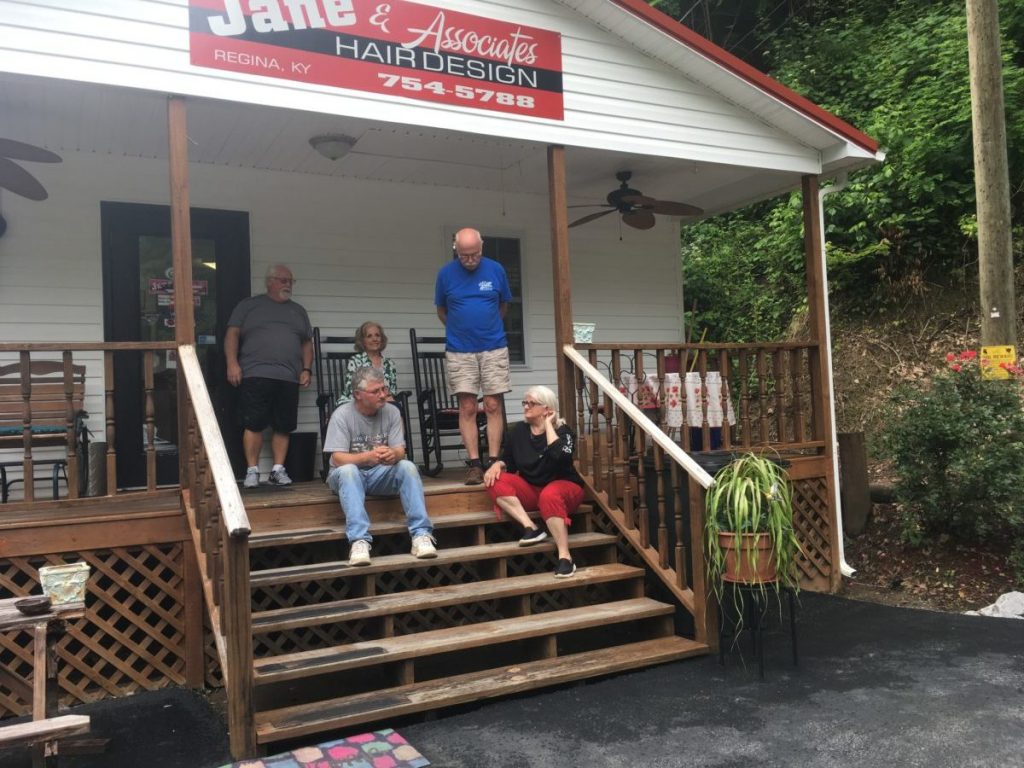 Todd Bentley’s family and neighbor sit at the hair salon owned by his mother, Janie Caudill, on Harless Creek Road in June. From right to left are Janie and Bob Caudill, Judi Casalino, Bentley and Lonnie Matney, their neighbor.