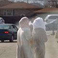 women walking down street with head covers