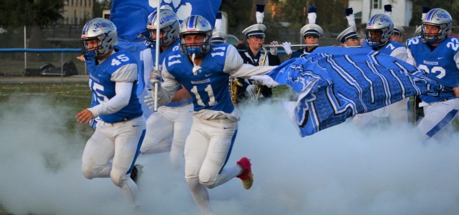 The Chillicothe Cavaliers run onto the field as get set to play the Washington Court House on Oct. 5, 2019.