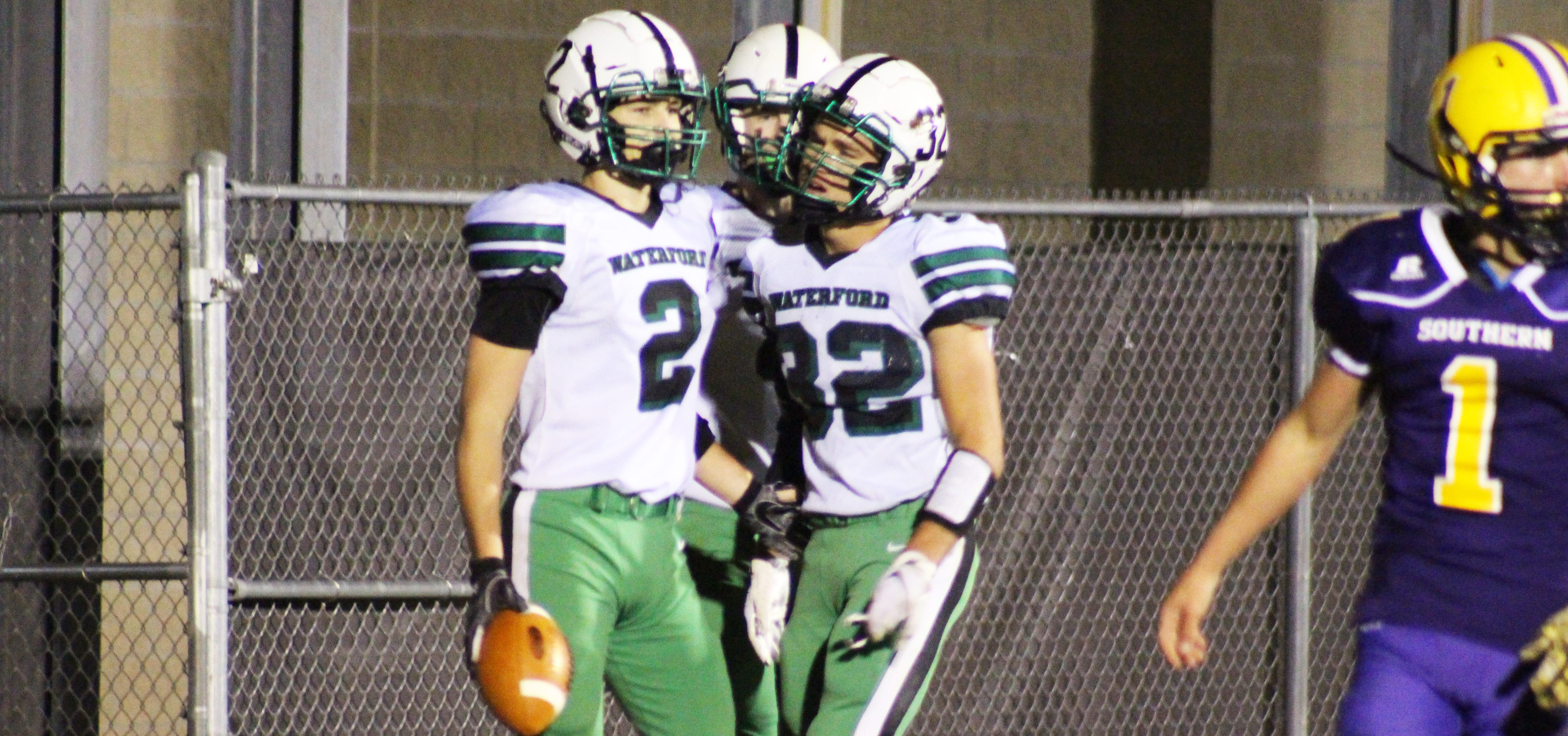 Waterford Wildcat players Joe Pantelidis and Holden Dailey celebrate after scoring a touchdown