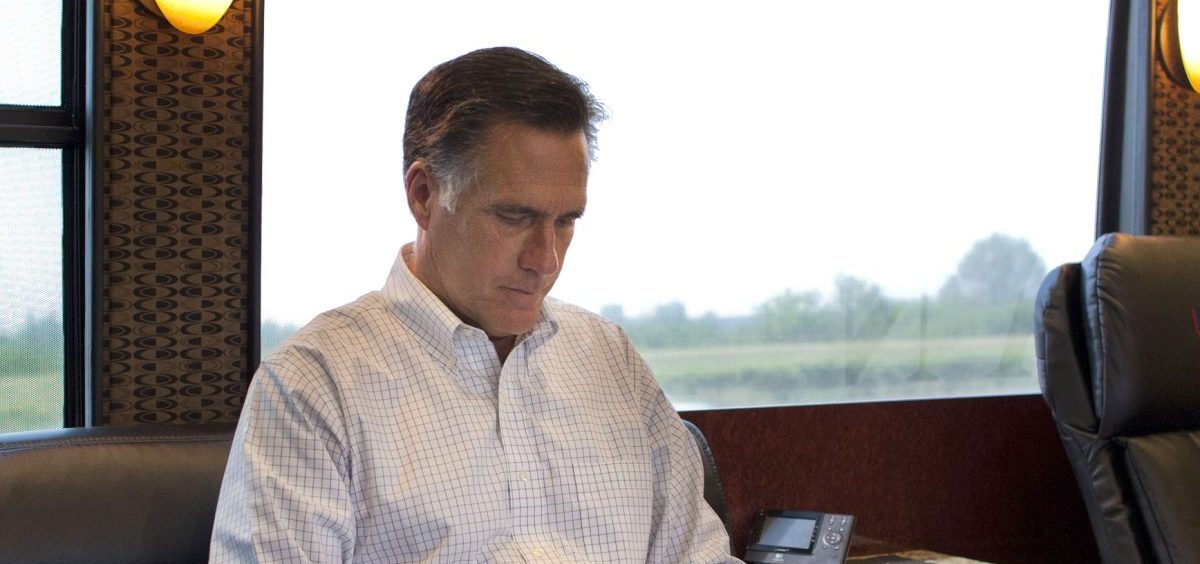 Mitt Romney, pictured riding on his campaign bus through Iowa during his 2012 presidential bid, has admitted to using a pseudonym on Twitter.