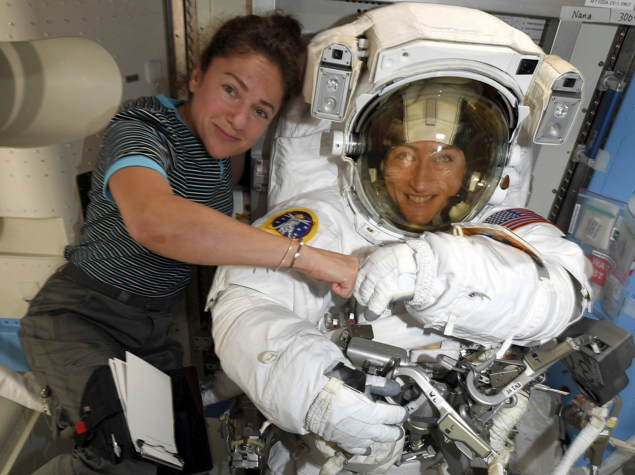 Astronauts Christina Koch (right) and Jessica Meir pose for a photo on the International Space Station on Oct. 4. NASA moved up the first all-female spacewalk because of a power system failure at the space station.