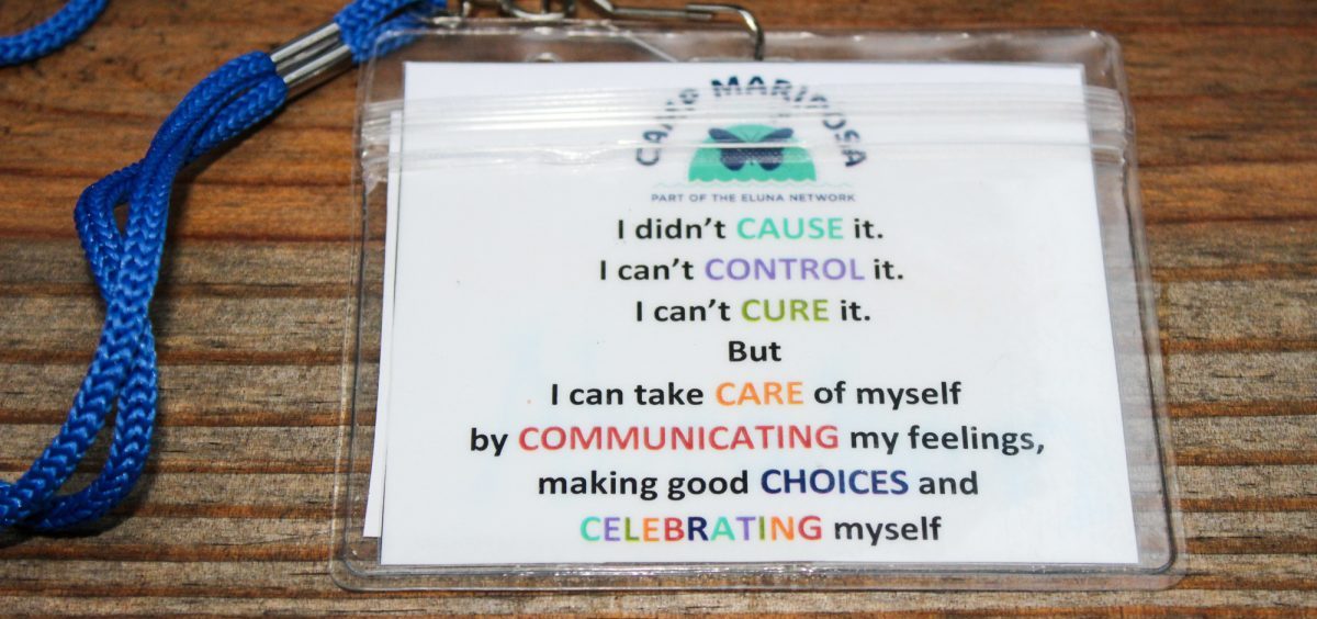 The lyrics of the Camp Mariposa song, "7 Cs," are printed out on lanyards so first time campers can sing along. One child said, "It helps me realize that I didn't cause what happened to me. It makes me feel much better."