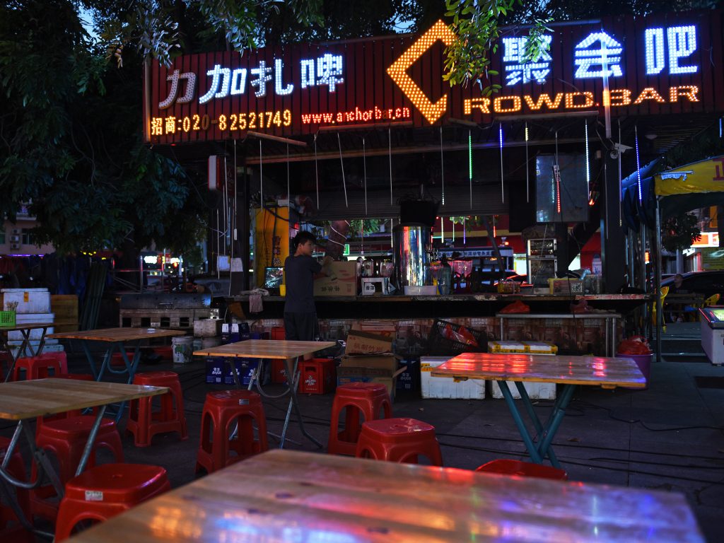 Crowdbar is a food stall in an open-air market in Dongguan, across the street from a factory complex that specializes in making shoes. "Right now, even the smallest vendors can't survive," Crowdbar's owner says.