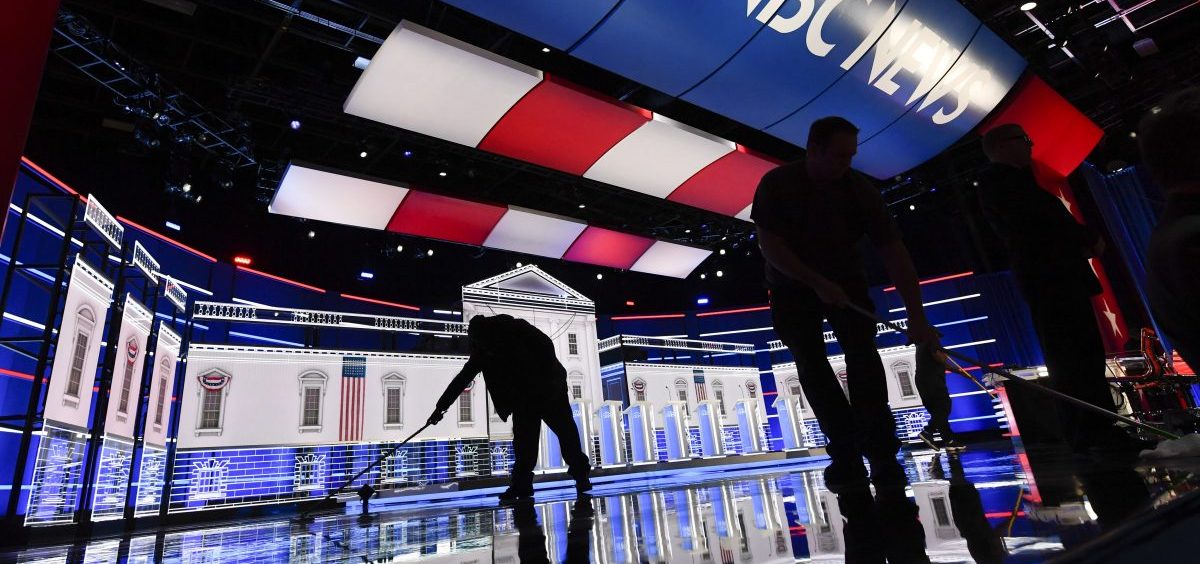 Workers clean the stage ahead of a Democratic presidential primary debate