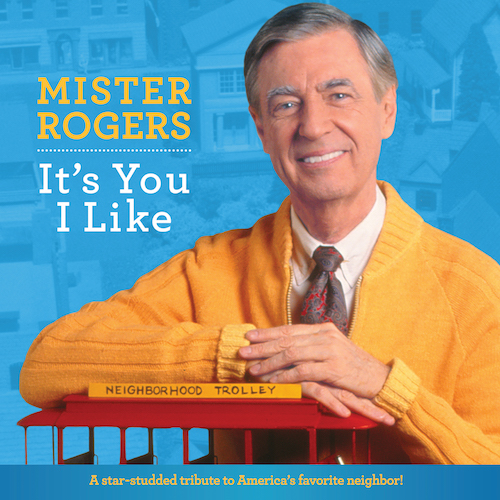 MISTER ROGERS smiling, leaning on trolley