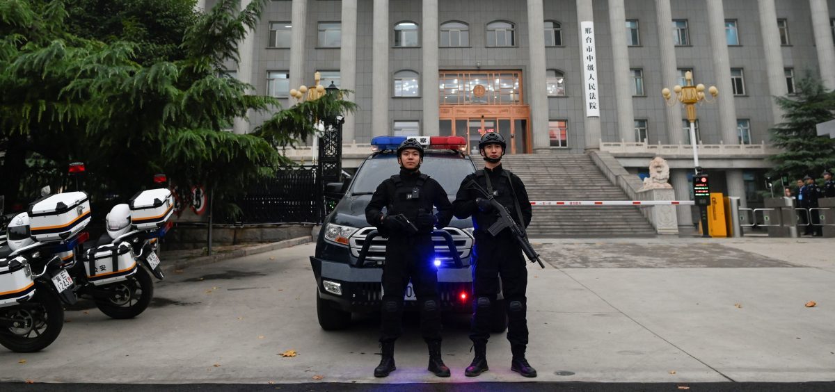 Police stand guard outside the Xingtai Intermediate People's Court in Xingtai, China's Hebei province, which issued stiff prison sentences to nine people caught in an illegal fentanyl ring.