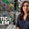 reporter standing in front of large plastic pile