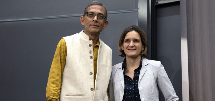 Esther Duflo, left, and Abhijit Banerjee stand together following a news conference at Massachusetts Institute of Technology in Cambridge, Mass., Monday, Oct. 14, 2019.
