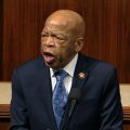 Rep. John Lewis, D-Ga., speaks as the House of Representatives debates the articles of impeachment against President Trump this month. Lewis says he'll stay in office while he undergoes treatment for pancreatic cancer.