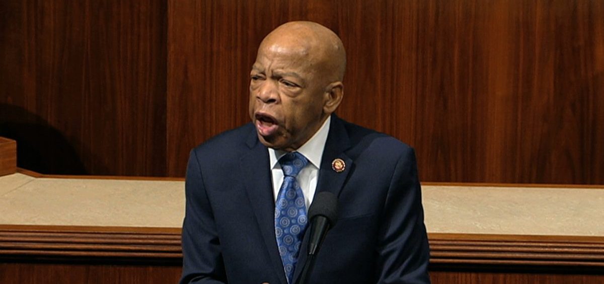 Rep. John Lewis, D-Ga., speaks as the House of Representatives debates the articles of impeachment against President Trump this month. Lewis says he'll stay in office while he undergoes treatment for pancreatic cancer.
