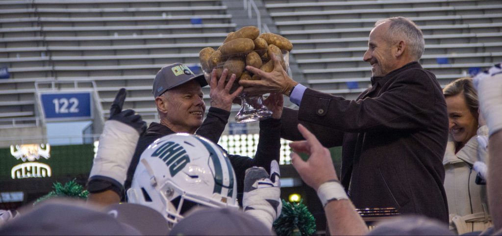 Bobcats Head Coach Frank Solich lifts the Potato Bowl trophy following Ohio's 30-21 win over Nevada on January 3, 2020. 