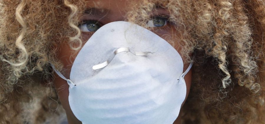 Levi Draheim, 11, wears a dust mask as he participates in a demonstration in Miami in July 2019. A lawsuit filed by him and other young people urging action against climate change was thrown out by a federal appeals court Friday.