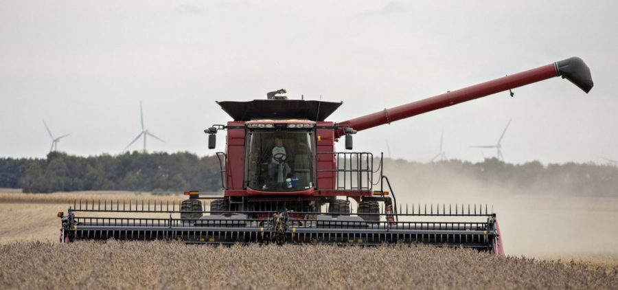 A farmer operates a combine to harvest soybeans in Wyanet, Ill. Farmers got more than $22 billion in government payments in 2019. It's the highest level of farm subsidies in 14 years.
