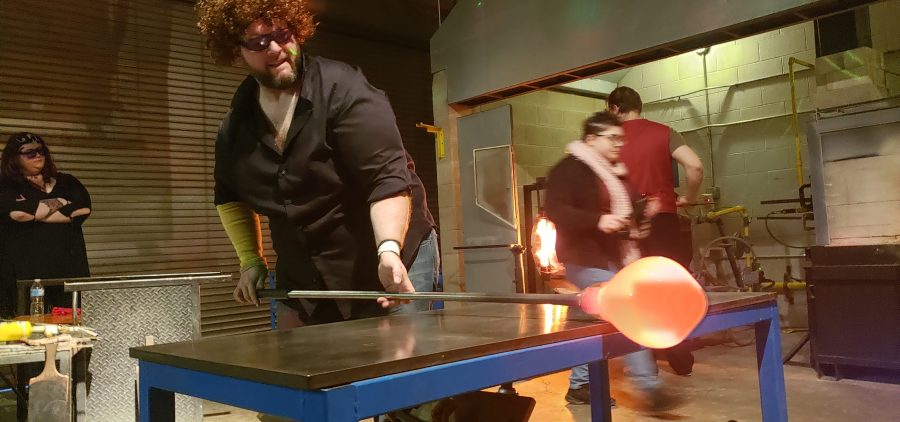 A man practices the art of glassblowing
